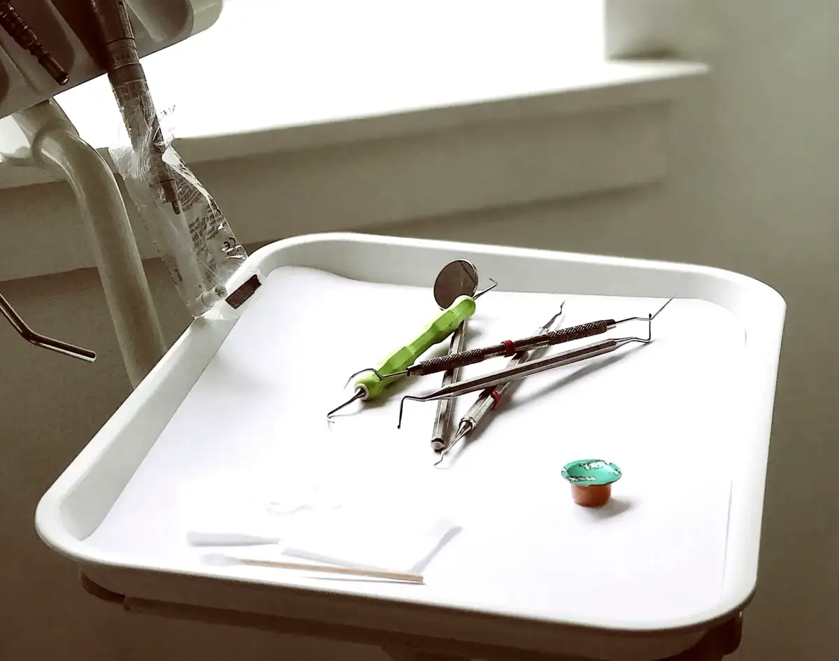 A dental instrument tray on an arm by a bright window (stock photo)