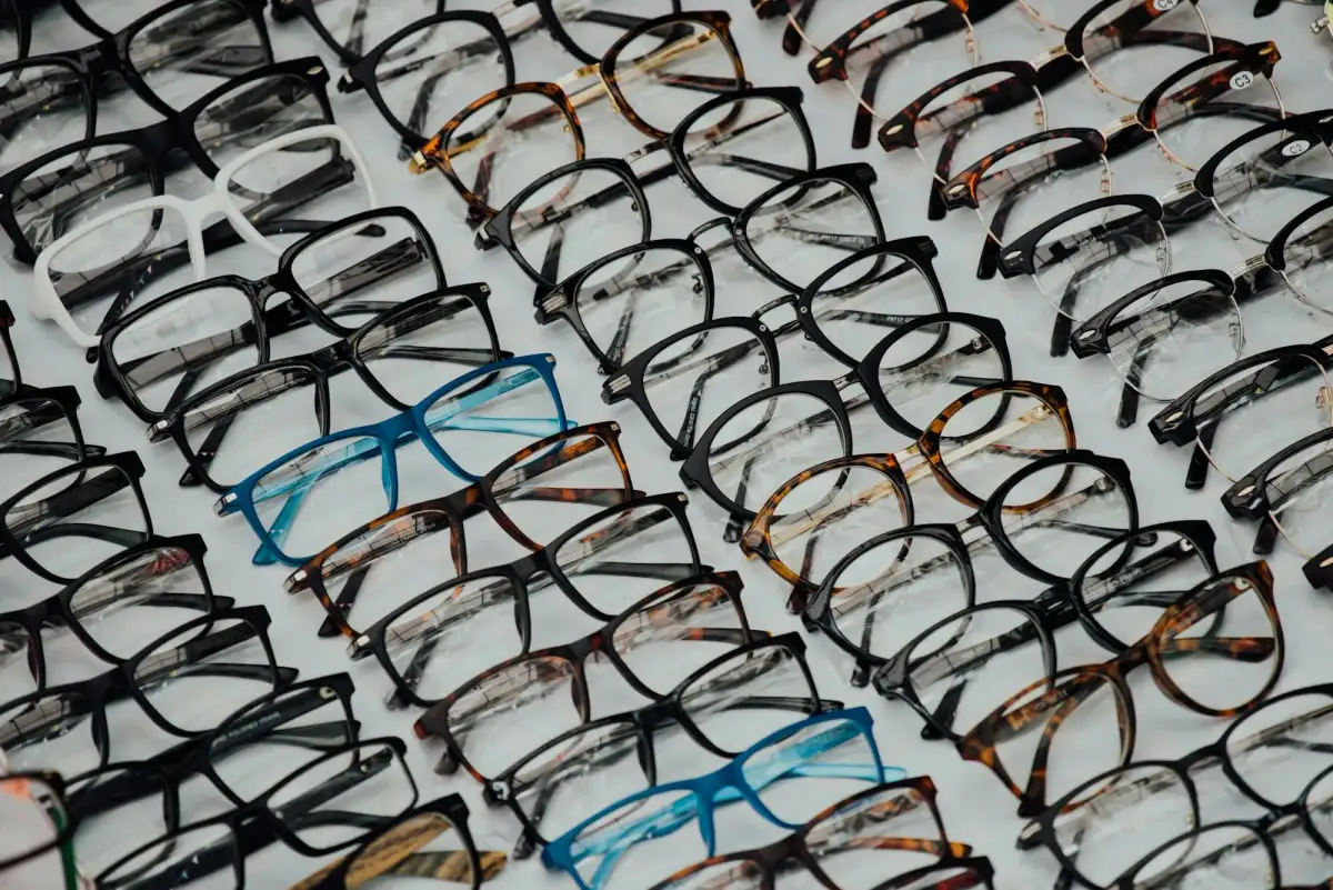 Rows of eyeglass frames on a white display (stock photo)